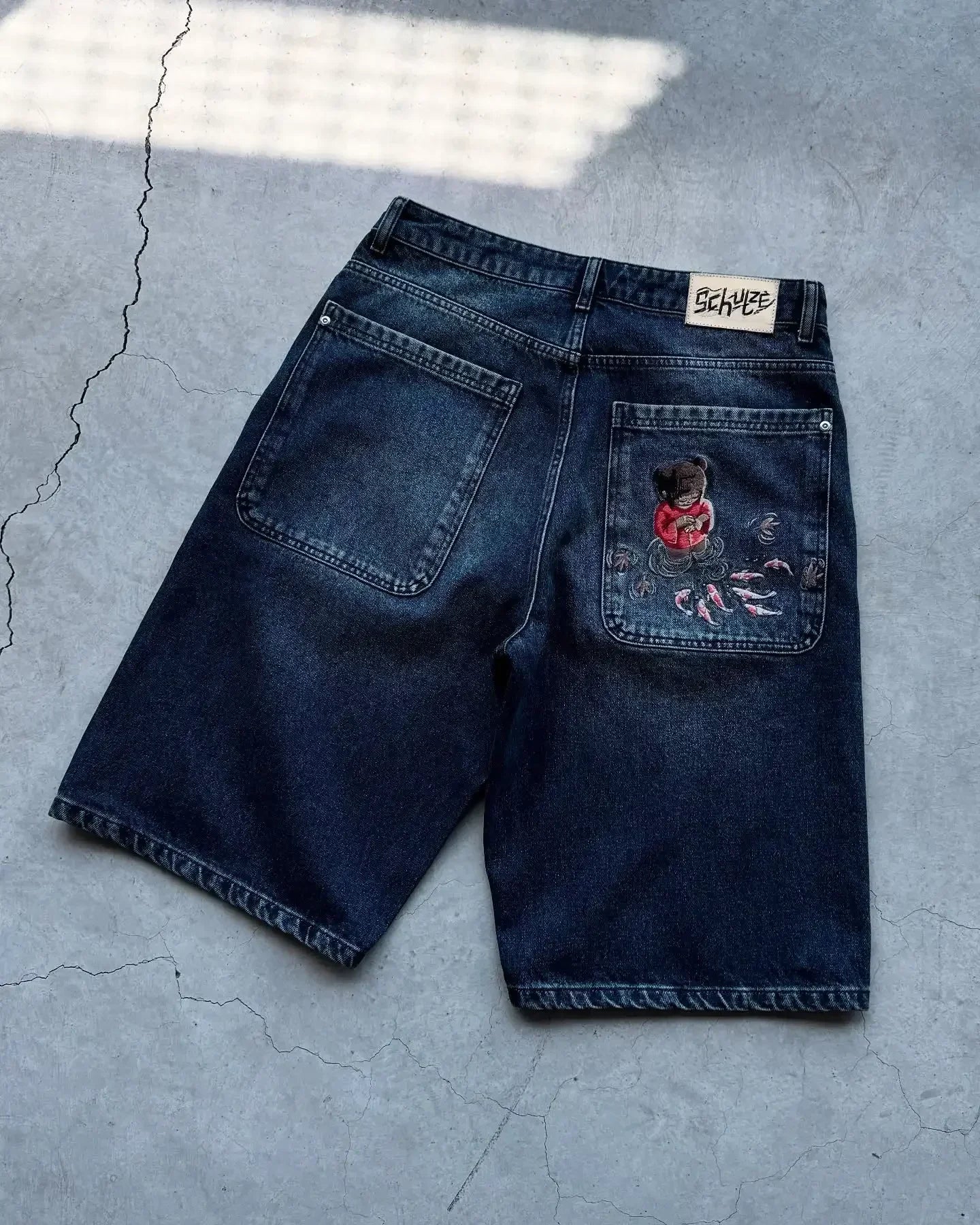 Vintage denim shorts by My Store, featuring distressed details and classic five-pocket style, shown on a casual model.