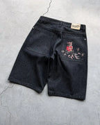 Vintage denim shorts with distressed details and rolled cuffs, styled with a casual summer look