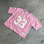 My Store 33 Jerseys collection featuring various sports jerseys with team logos and vibrant colors displayed on hangers.