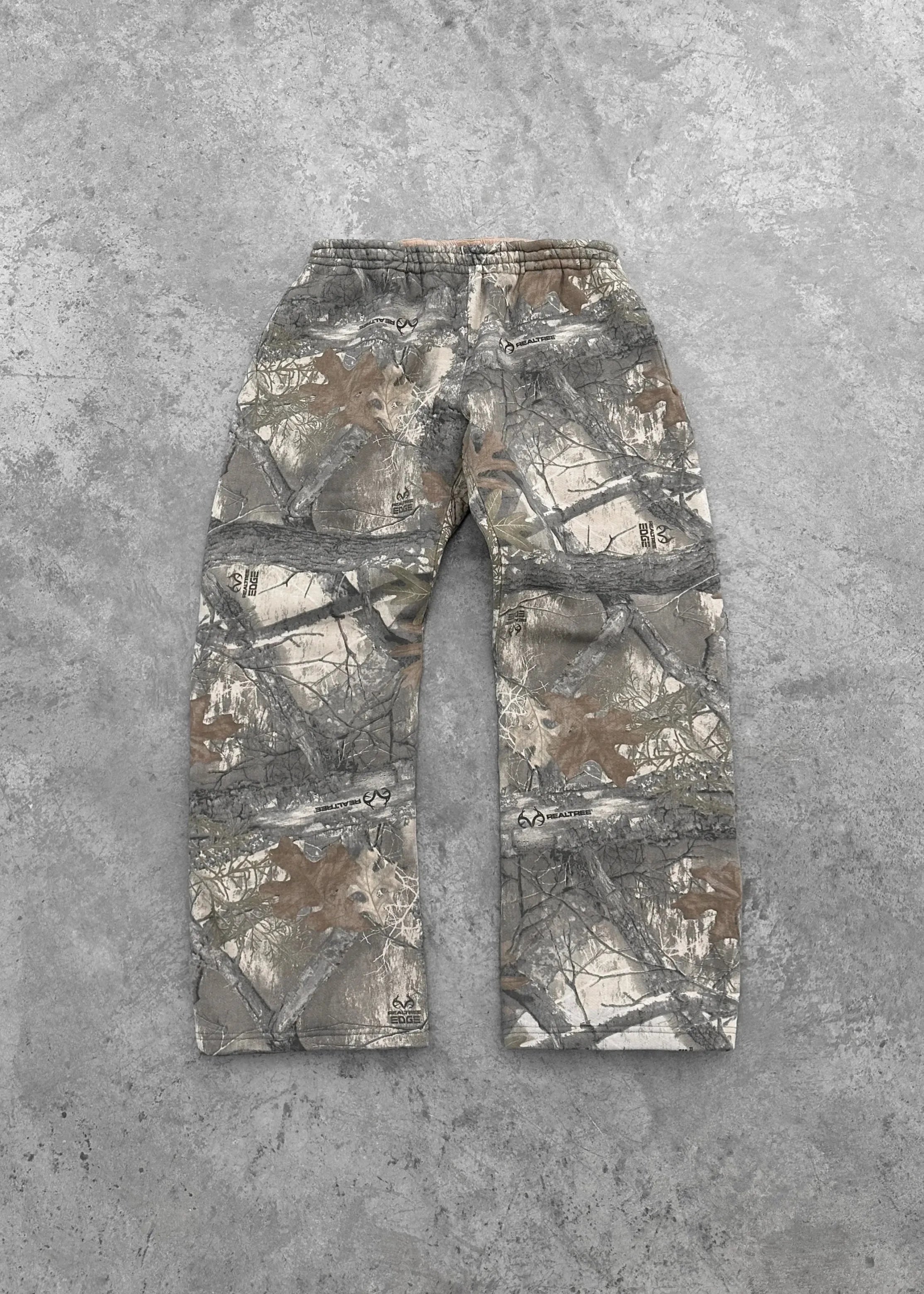 CamoPattern pants by My Store featuring a camouflage design, tailored fit, and casual style, displayed on a mannequin.