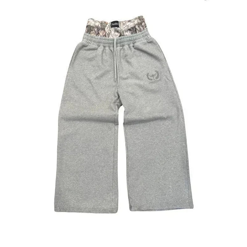 NOIZSY double waist baggy pants featuring a relaxed fit, shown in a neutral color with adjustable waistband and side pockets.