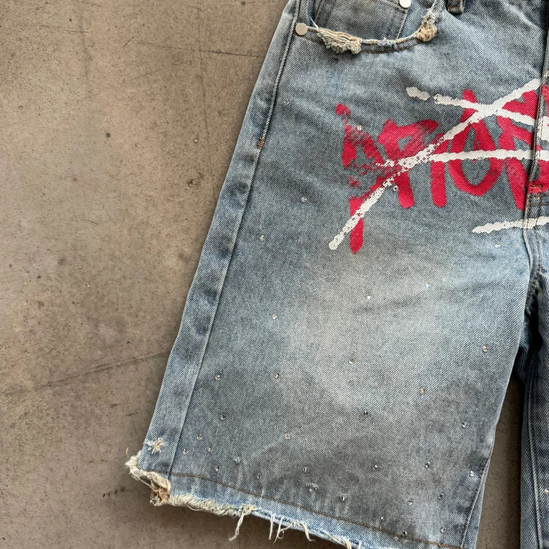 Light blue Y2K graffiti design denim jorts with distressed details, stylish casual shorts from My Store.