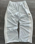 NOIZSY striped baggy pants with wide legs and relaxed fit, featuring horizontal black and white stripes, front pockets, and drawstring waist