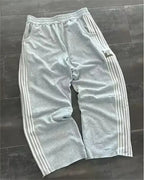 NOIZSY striped baggy pants featuring a relaxed fit with bold stripe patterns and a comfortable waistband.
