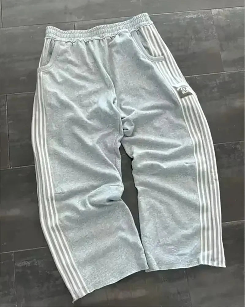 NOIZSY striped baggy pants featuring a relaxed fit with bold stripe patterns and a comfortable waistband.