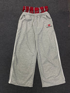 NOIZSY double waist red baggy pants with relaxed fit and bold style, shown in a close-up image emphasizing the fabric and color.