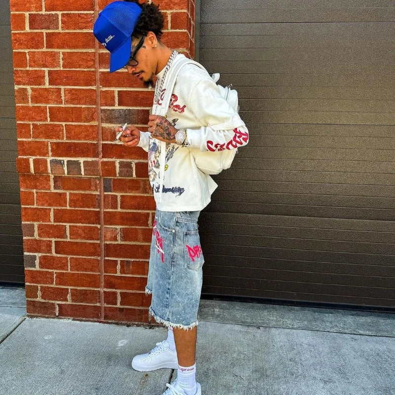 Y2K graffiti-style denim jorts with colorful paint splatter design, casual fit, and distressed details from My Store.