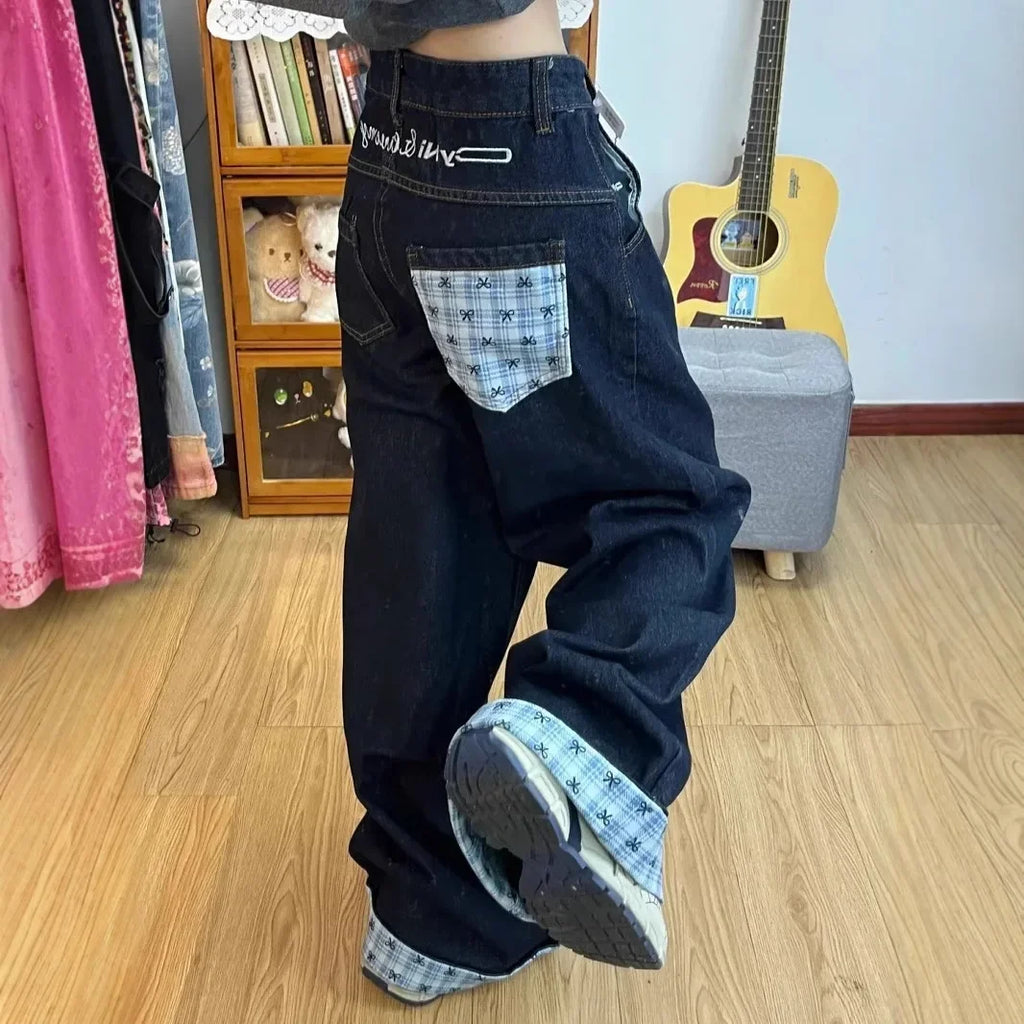 Drapey wide-leg denim jeans by My Store, featuring a relaxed fit and classic blue wash, displayed hanging on a clothing rack.