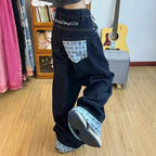 Drapey wide-leg denim jeans by My Store, featuring a relaxed fit and classic blue wash, displayed hanging on a clothing rack.