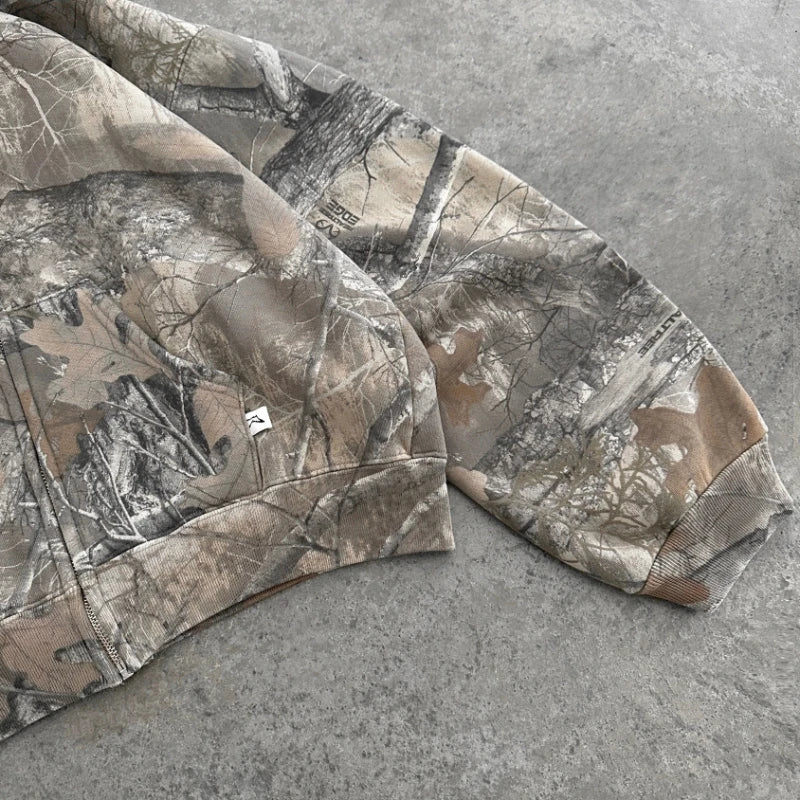 Camouflage pattern from My Store's Camo Collection displayed on fabric with earthy green and brown tones.