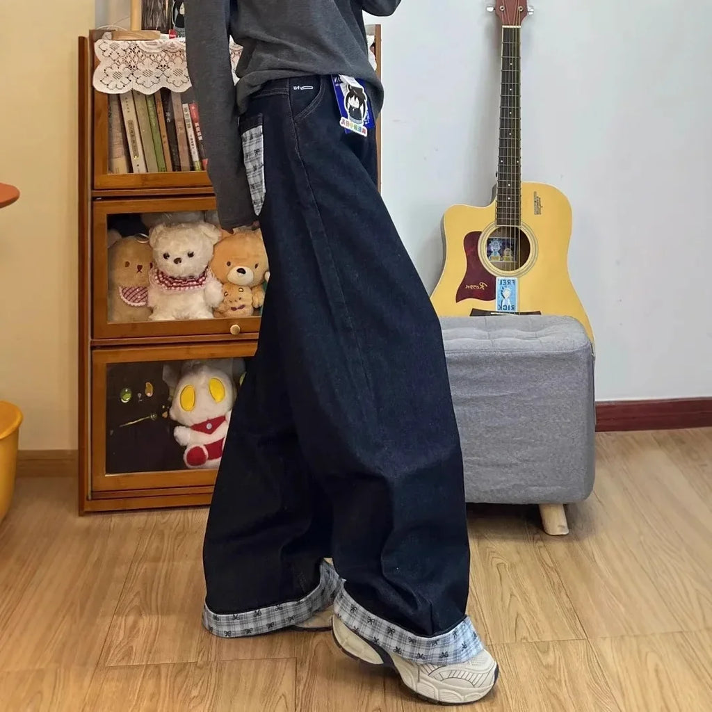 Drapey wide-leg denim jeans by My Store displayed on a hanger, showcasing their relaxed fit and stylish drape.