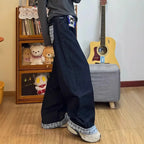 Drapey wide-leg denim jeans by My Store displayed on a hanger, showcasing their relaxed fit and stylish drape.