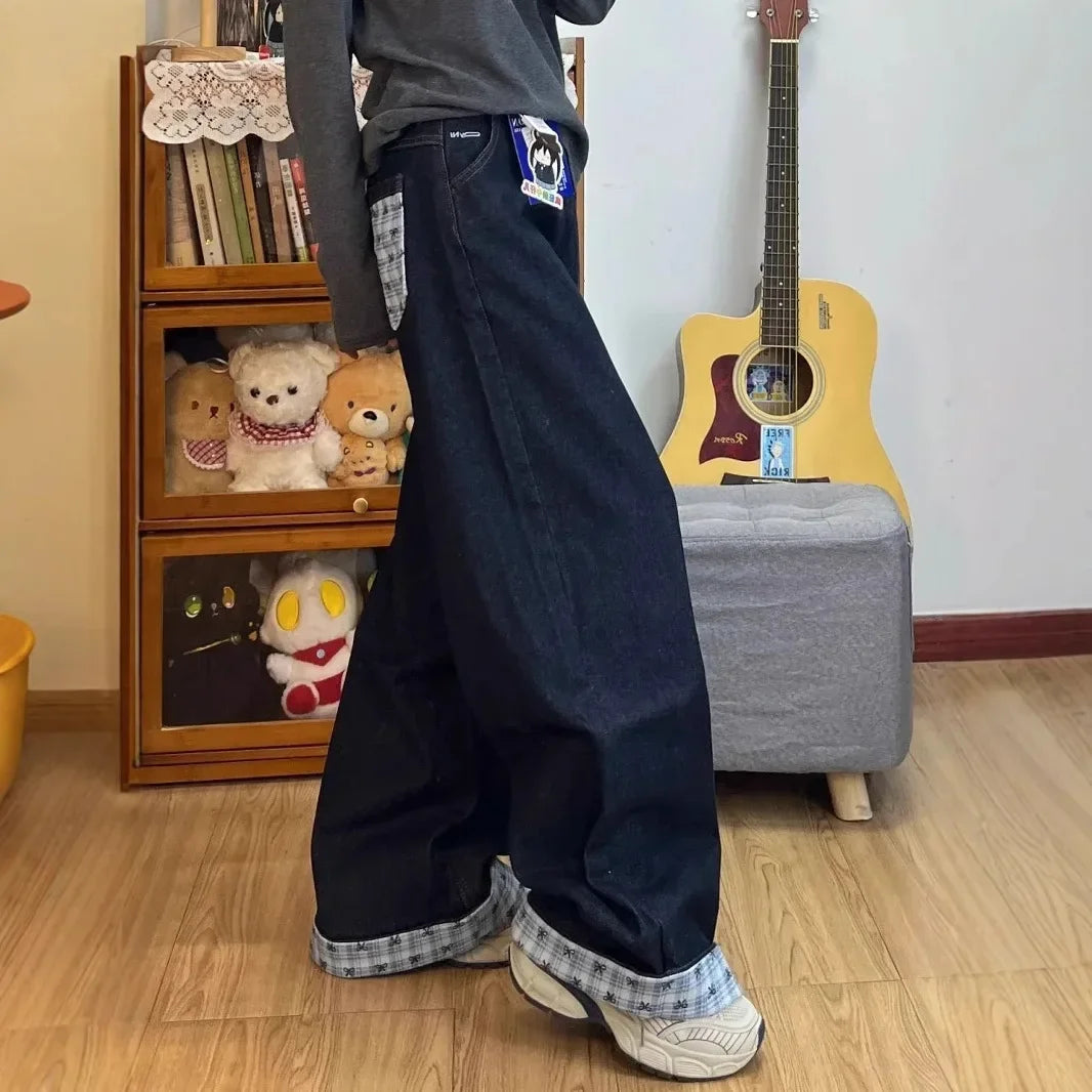 Drapey wide-leg denim jeans by My Store displayed on a hanger, showcasing their relaxed fit and stylish drape.