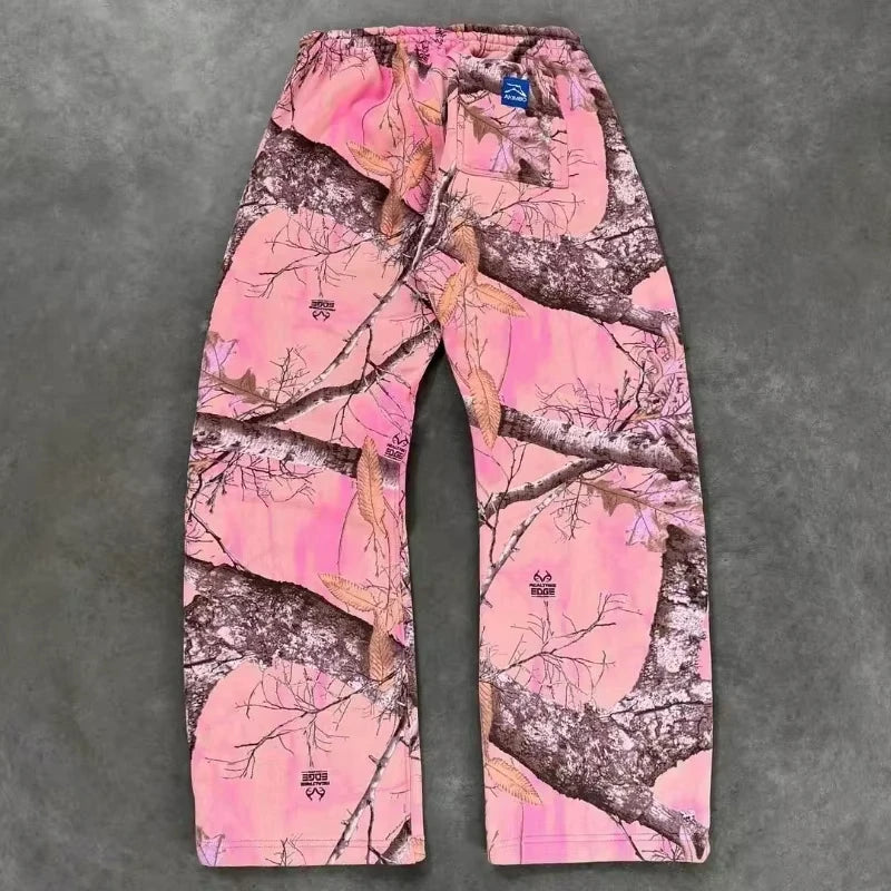 CamoPattern pants by My Store featuring a green and brown camouflage design, displayed on a hanger against a plain background.