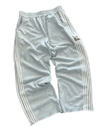 NOIZSY striped baggy pants with a relaxed fit, featuring bold vertical stripes and a comfortable, casual style.