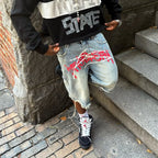Y2K graffiti-style denim jorts with colorful street art design, casual cut, and distressed details, perfect for trendy summer outfits.