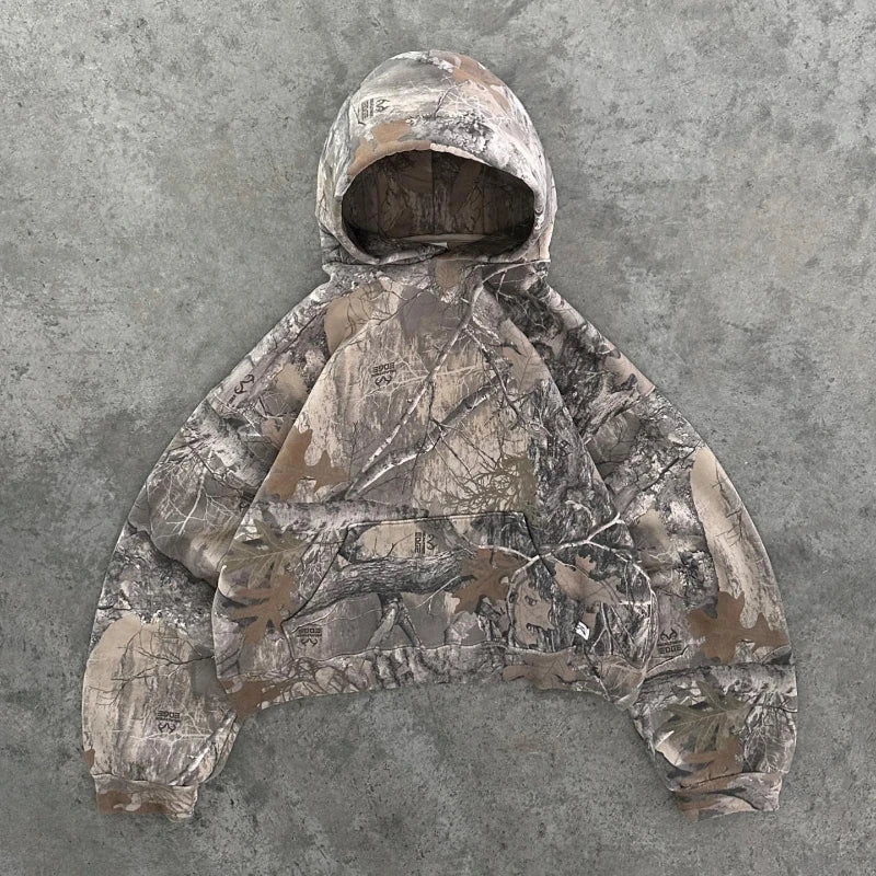 Camouflage pattern from the My Store Camo Collection featuring a close-up of fabric with green, brown, and black camo design.